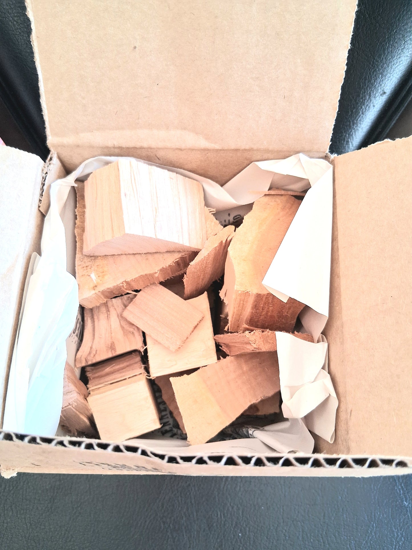 Box of wooden blocks on a blue surface